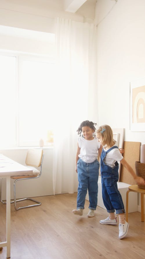 Two Girls Dancing Indoors