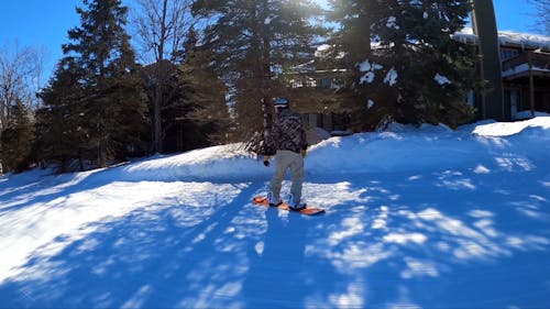 Person Snowboarding on Snow Mountain