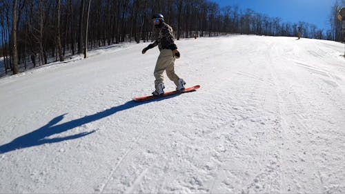 A Person Snowboarding Downhill