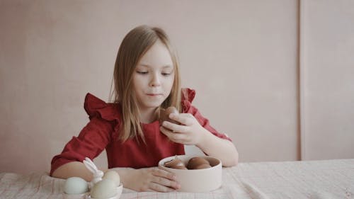 Girl Eating a Chocolate Egg