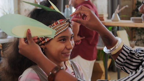 A Mother Putting a Bunny Ears on Her Daughter's Headband