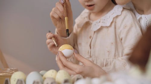 Mother and Daughter Painting the Eggs