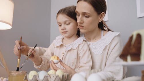 Mother and Daughter Painting the Eggs