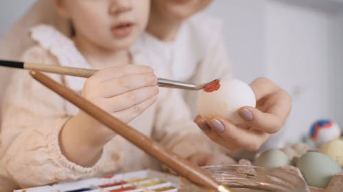 Mother and Daughter Painting Eggs