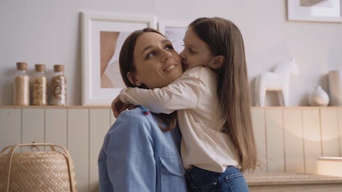 Little Girl Kissing Her Mother