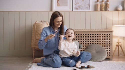 Mother and Daughter Holding a Toothbrush