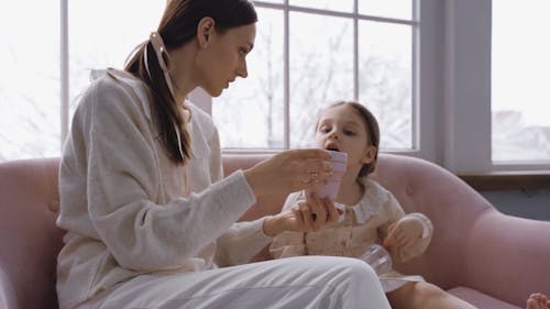 Mother and Daughter Sitting on the Sofa