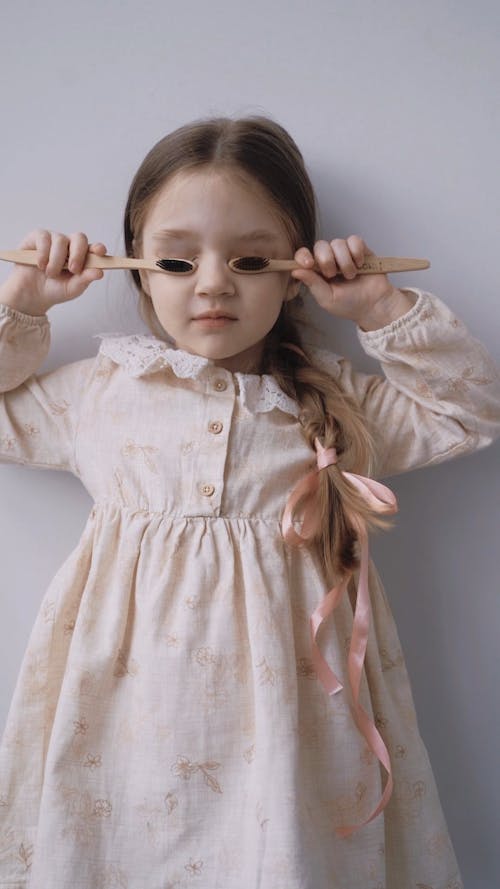 Little Girl Holding Wooden Toothbrush