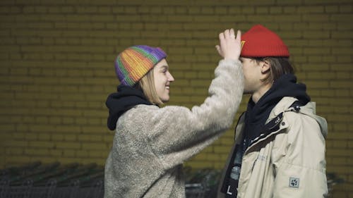 Young Couple Covering Each Others Face with Beanie