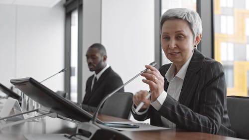 Female Asking a Question in a Meeting at a Conference Room