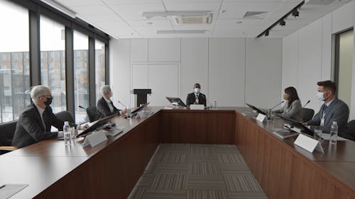 People Wearing Face Masks are Having A Meeting at the Conference Room