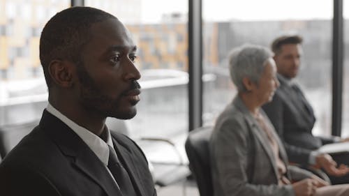 A Group of People Listening to Someone Talking