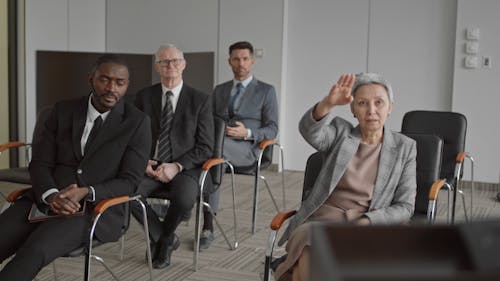 Woman Raising Hand to Ask a Question 