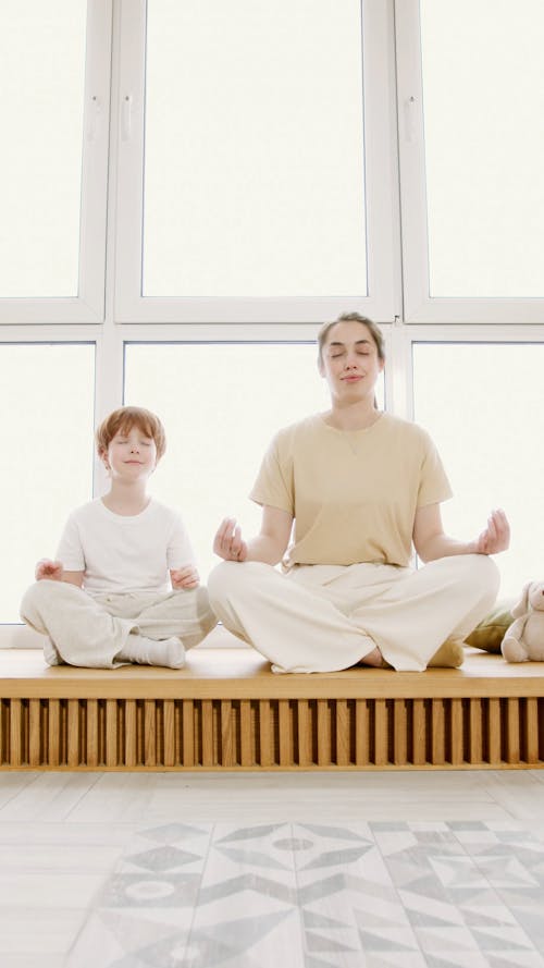 A Little Boy and a Woman Meditating 
