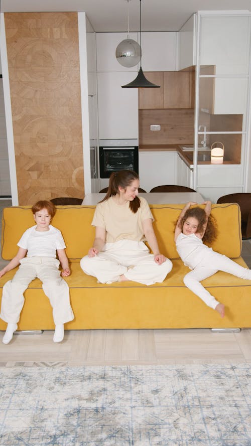 Woman Sitting on Sofa With Her Children