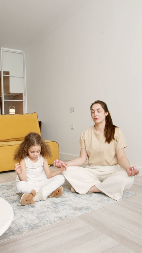 Mother & daughter meditating