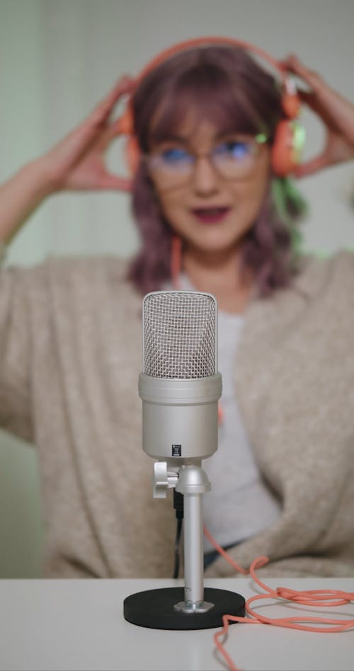 Woman Talking on a Microphone