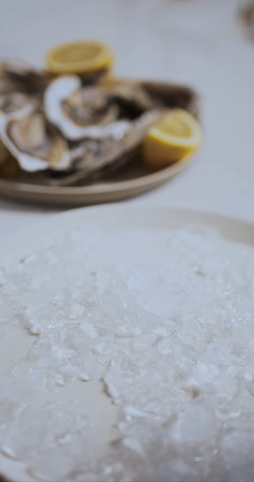 Person Placing Oyster In A Plate