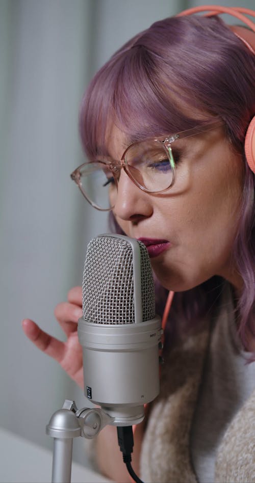 A Woman Making Sounds Using a Microphone