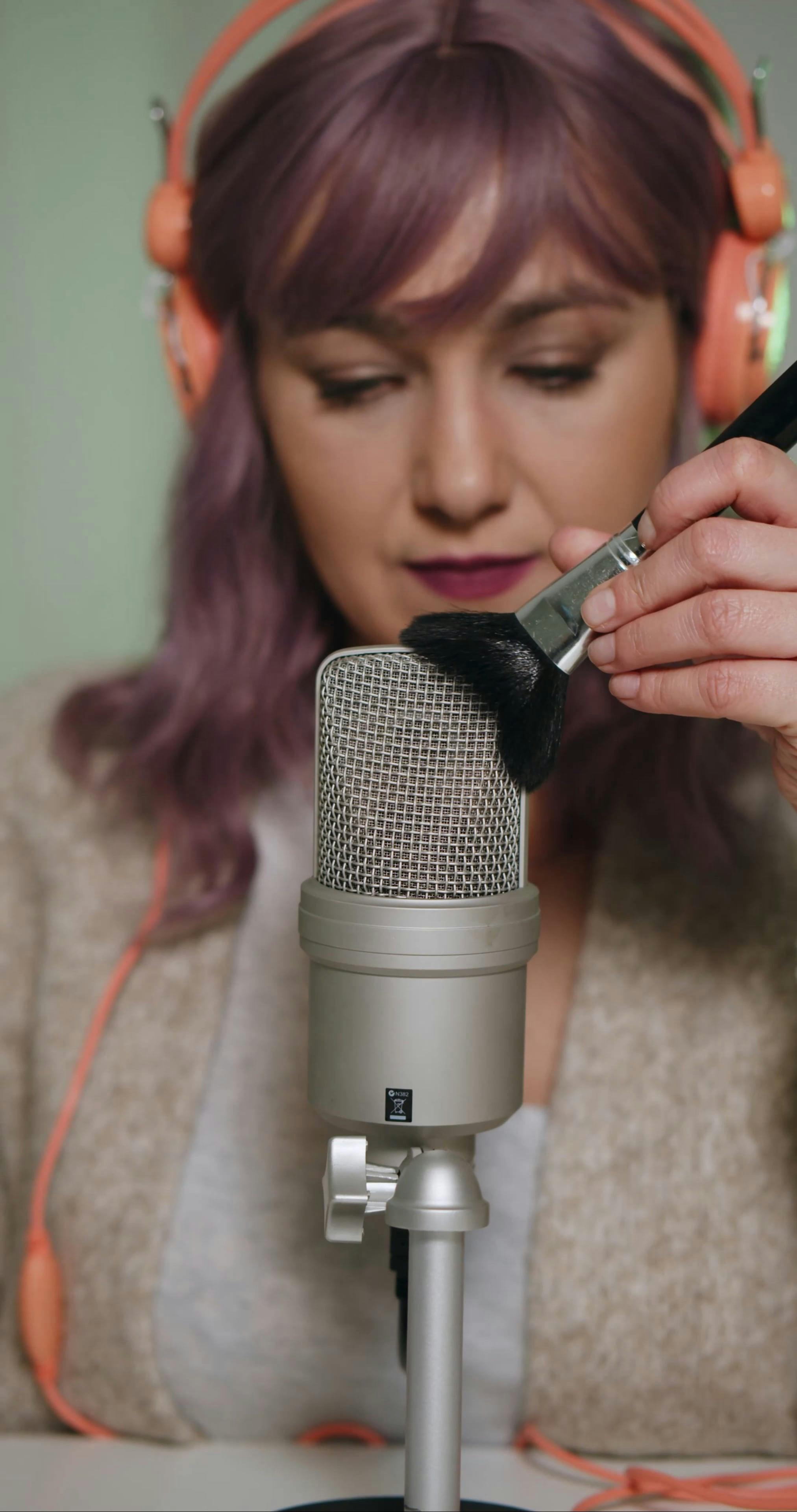 Woman Putting Makeup Brush on Microphone · Free Stock Video