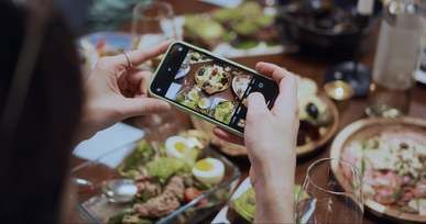 a person taking photos of the food