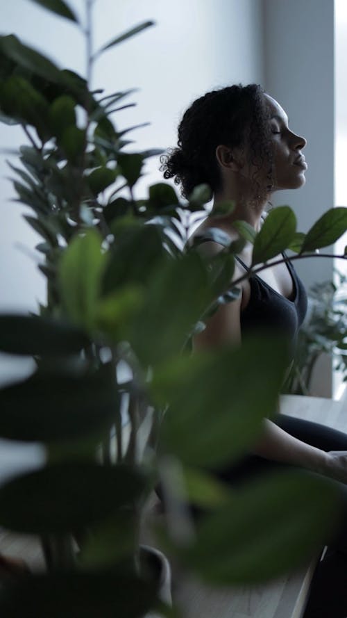 Side View of a Woman Sitting While Eyes are Closed