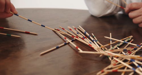 Close-up Video of People Playing Pick-up Sticks