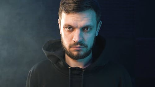 Man Wearing Hoodie Looking at Camera