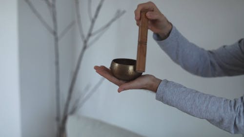 A Person Using Singing Bowl