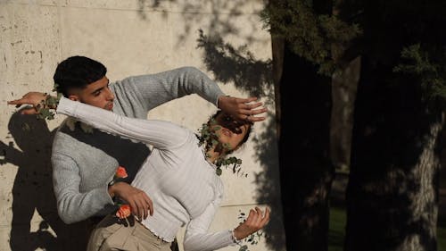 Man and Woman Dancing with Flowers and Leaves on Sleeves