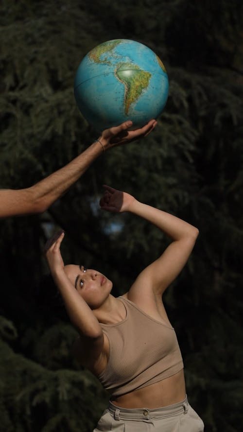 Woman Dancing Beneath a Globe