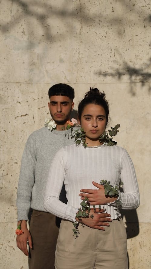 Man and Woman with Plants Inside Their Shirts