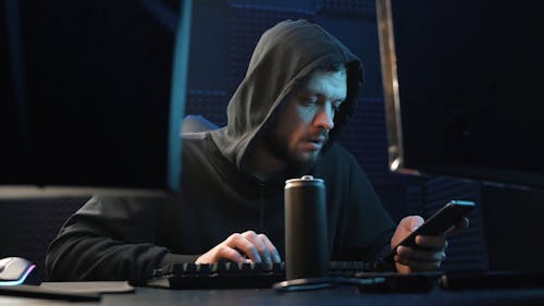 Man in a Hoodie Annoyed after Looking at Screen