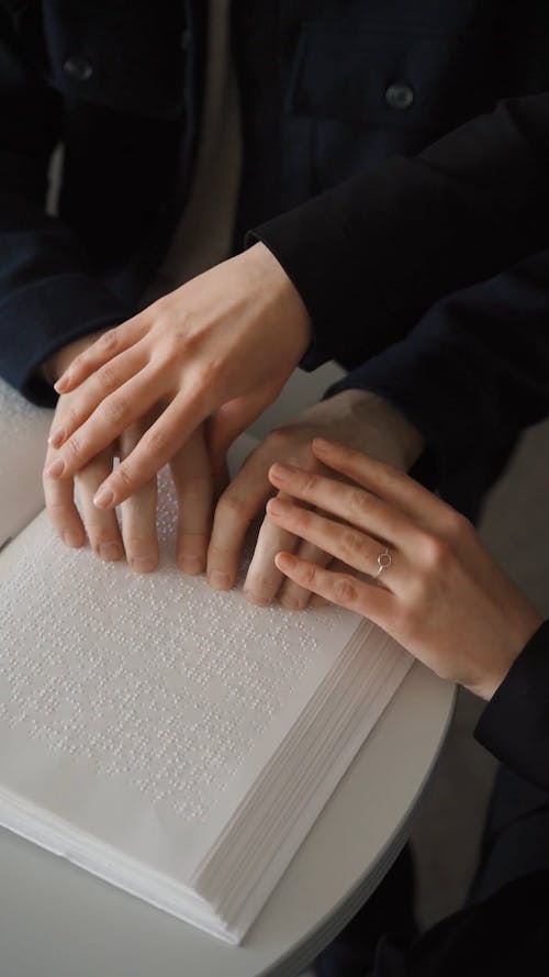 Close-Up Video of Hands Using Braille