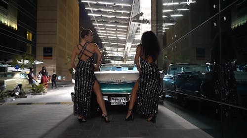 Women Posing And Modeling Beside the Luxury Car
