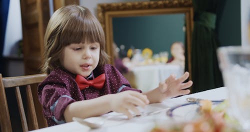 A Child Holding Spoon and Fork