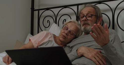 Elderly Couple Sharing a Laptop