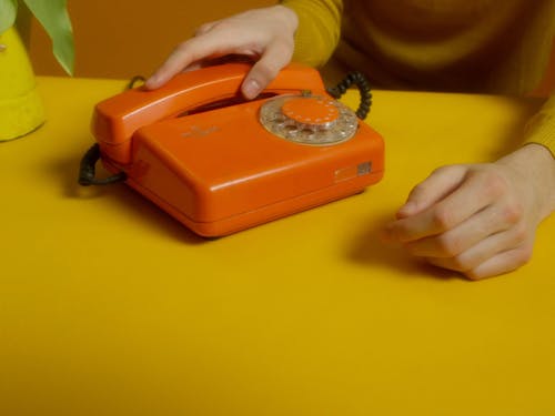 A Young Man Using A Telephone