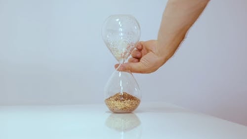 Person Turning Hourglass