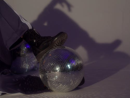 Model Posing on the Floor while Stepping on Disco Ball