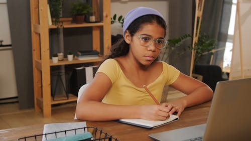 Girl Writing on Notebook