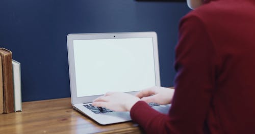 A Woman Typing On Her Laptop