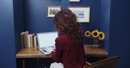 A Woman Working At Home With A Laptop