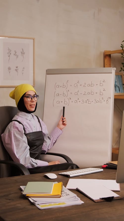 A Woman Explaining a Math Formula