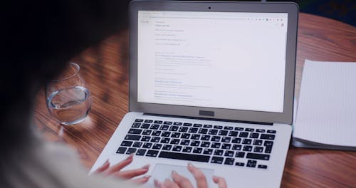 A Woman Using The Internet With A Laptop