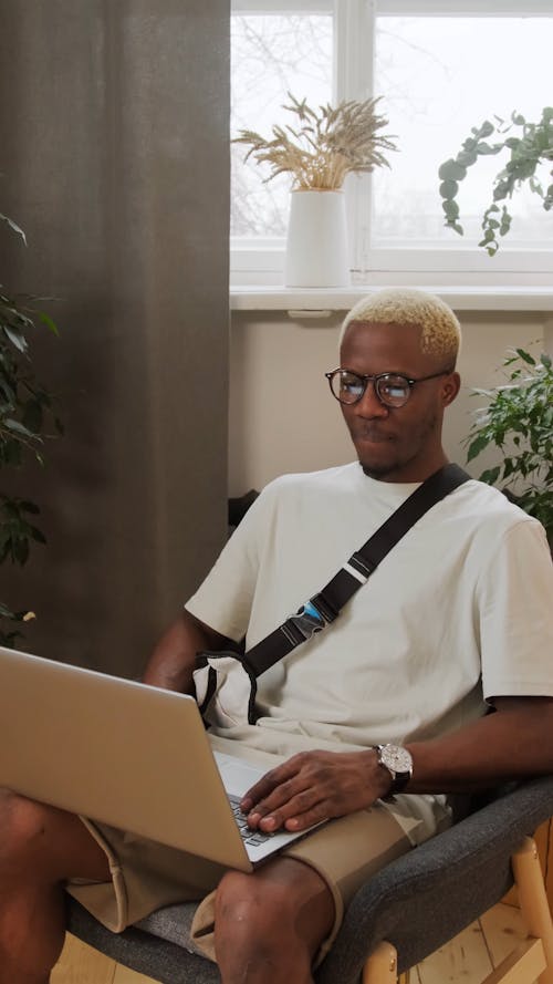 A Man Communicating Using A Laptop