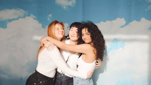 Three Young Women Embracing Each Other