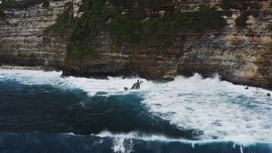drone footage of cliffside and sea waves