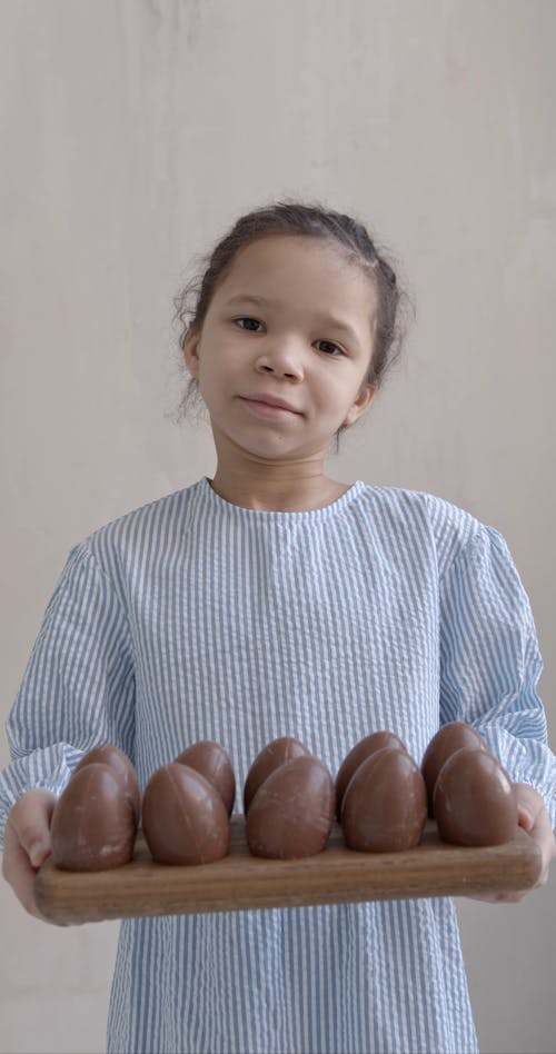 Girl Holding Tray of Chocolate Eggs