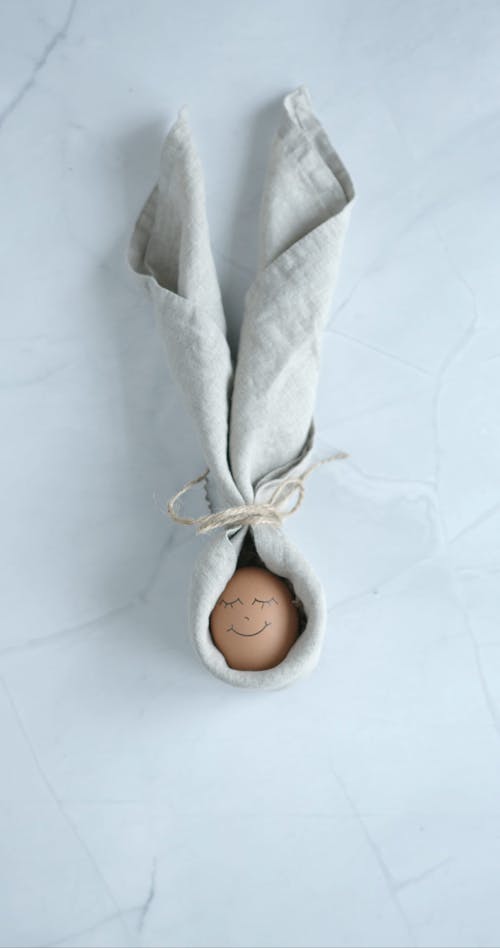 An Egg with a Smiley Face Tied to a Cloth